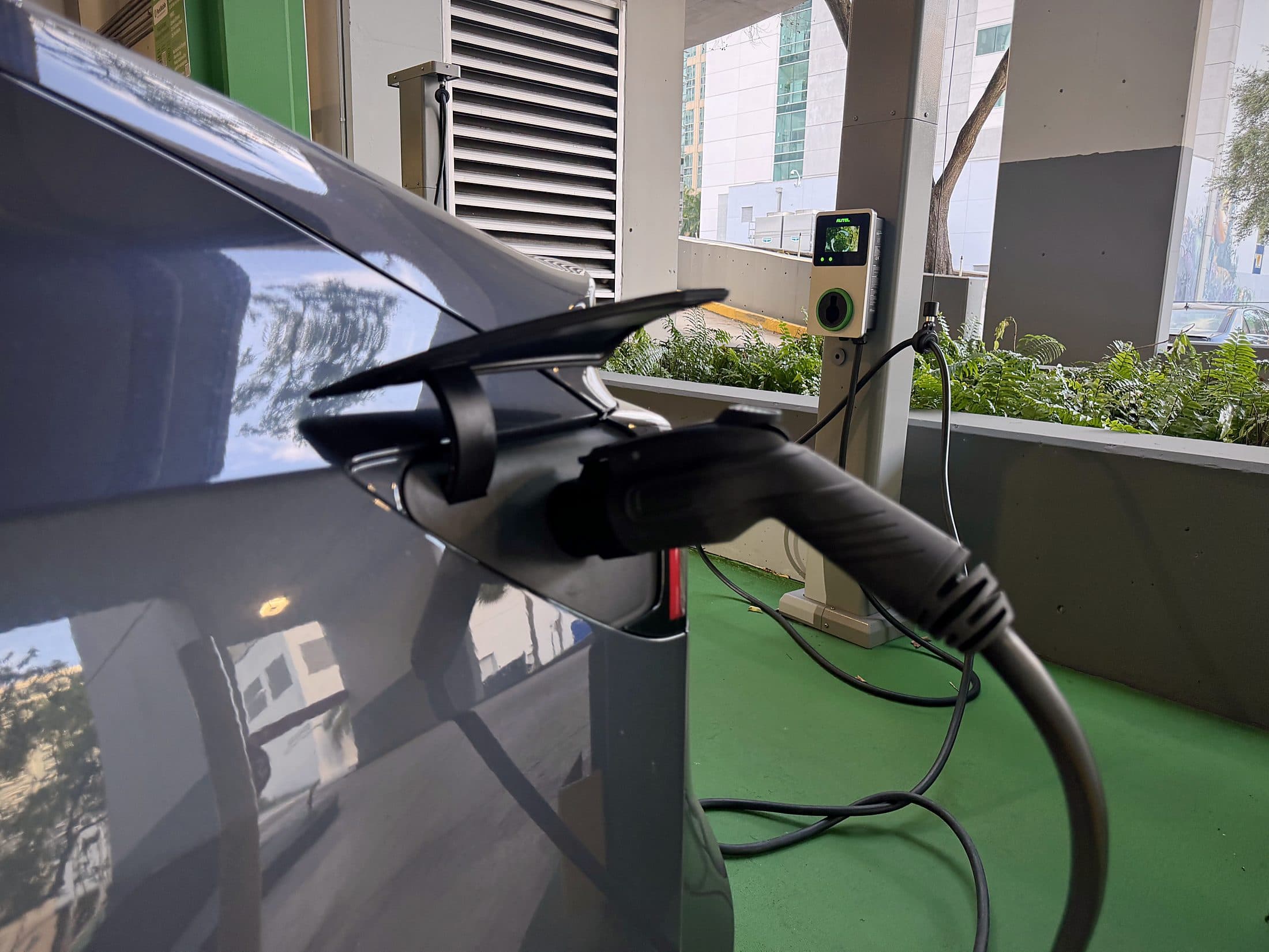 Electric vehicle charging at a US Supercharge station in a parking garage