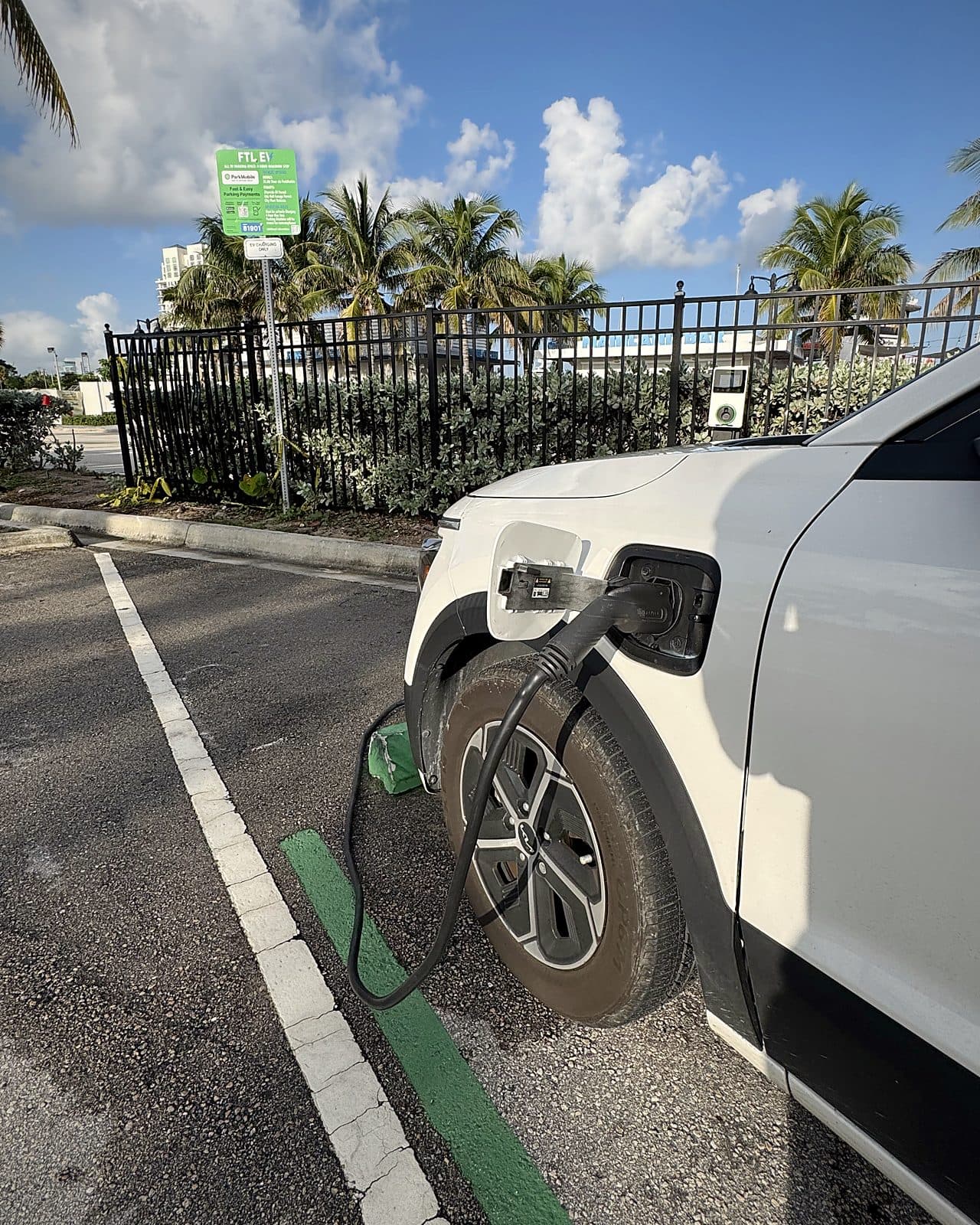 Electric vehicle plugged in and charging at a US Supercharge station