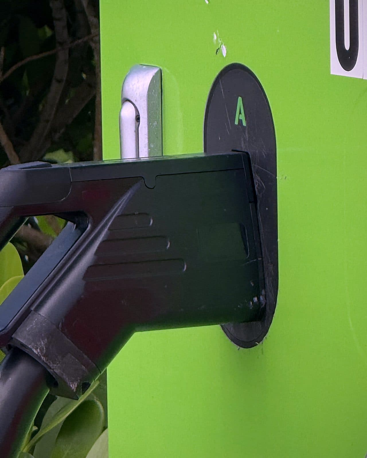 Charging connectors holstered on a US Supercharge DC fast charger